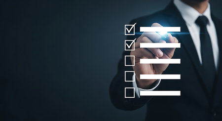 Man in suit checking off items on a digital to do list checklist taskの素材