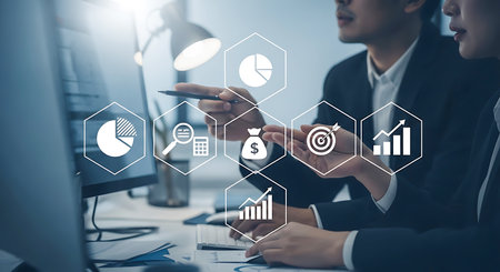 Two people in suits discuss financial data with hexagonal icons showing charts money and targetsの素材