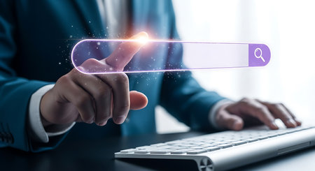A person in a blue suit touches a glowing purple search bar with a magnifying glass icon. A keyboard is visible in the foreground.の素材