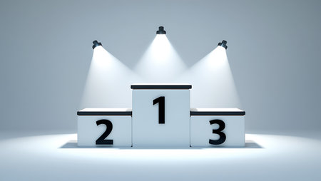 A white three-tiered podium with black numbers 1 2 3 is lit by three overhead spotlights against a pale blue background.の素材