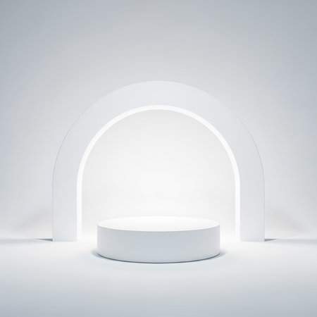 A white cylindrical podium sits centered under a large white archway in a bright, minimalist studio setting.の素材