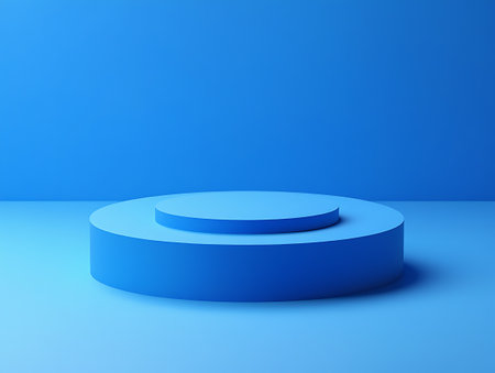 A two-tiered blue cylinder podium sits on a lighter blue surface against a solid blue background.の素材