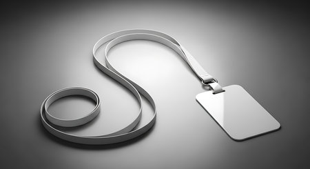 A white lanyard with a blank rectangular badge hangs on a smooth gray gradient surface with soft shadows.の素材
