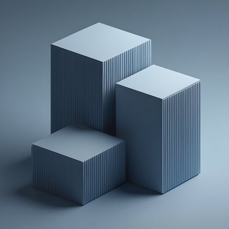 Three ribbed geometric pedestals of varying heights and sizes are arranged on a soft grey background with subtle shadows.の素材