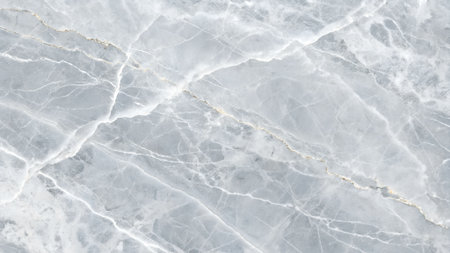 Close-up view of a light blue marble surface with intricate white veining and subtle gold streaks creating a natural abstract pattern.の素材