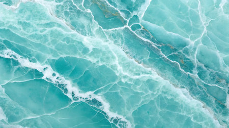 Close-up of a polished aqua blue marble surface with intricate white veining and subtle gold mineral inclusions creating a fluid, organic pattern.の素材