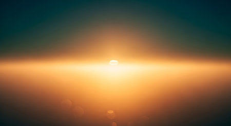 A blurred sunset with a bright orange glow on the horizon and bokeh circles in the foreground.の素材