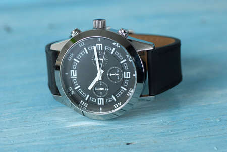 Wristwatch on old wooden table