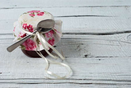 Jam in jar on old wooden tableの写真素材