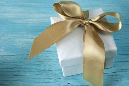 Gift box with ribbon on old wooden tableの写真素材