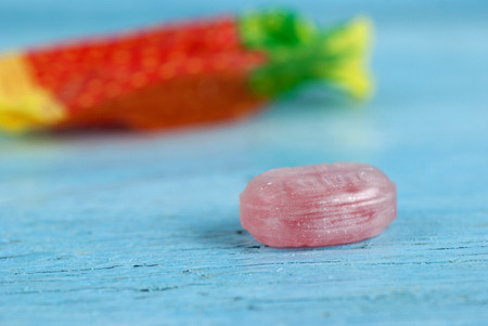 Wrapped candy on old wooden table