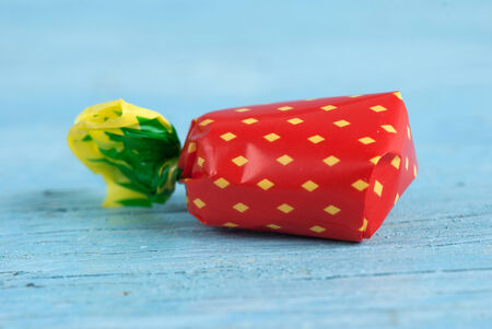 Wrapped candy on old wooden table