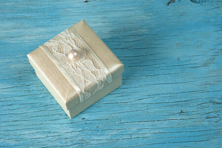 Gift box with ribbon on old wooden table
