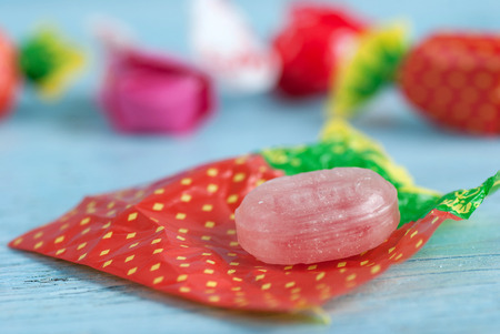 Wrapped candies on old wooden tableの写真素材