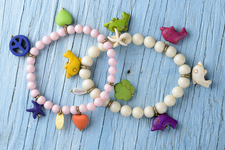 Bracelets on old wooden tableの写真素材