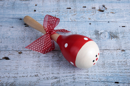 Maracas with ribbon on old wooden table