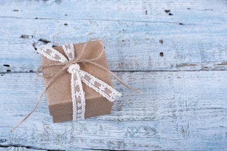 Gift box with ribbon on old wooden tableの写真素材