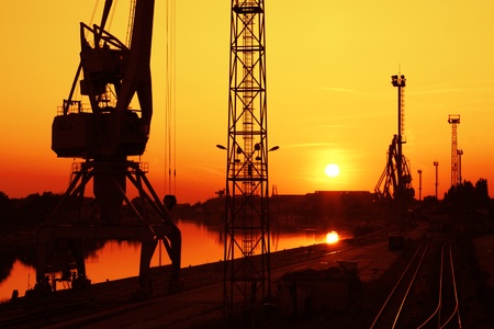 Crane and towers in the sunset