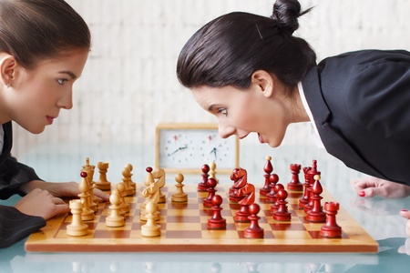 Young women playing chess, tactics, queen gambitの写真素材