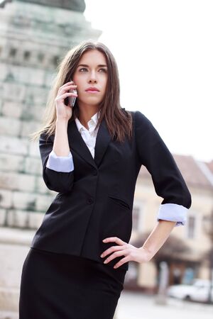 Attractive businesswoman calling by smartphoneの写真素材