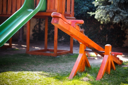 Old wood seesaw with slider system, kindergartenの写真素材