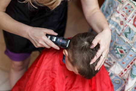 Haircut for boy at home with machineの写真素材