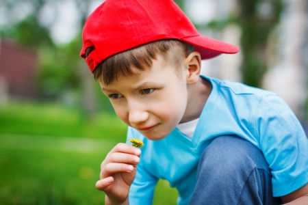 Little explorer kid smelling dandelionの写真素材