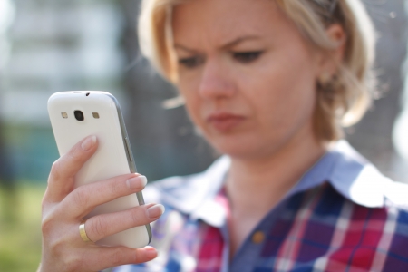 Young blonde woman got bad newsの写真素材