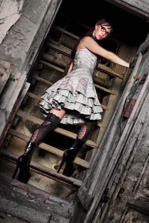 Sexy young brunette woman posing on ladderの写真素材