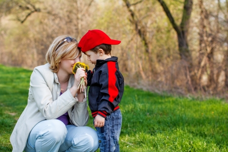 Mother and little boy with dandelion flowersの写真素材