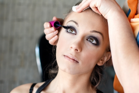 Makeup artist applying eyelash for modelの写真素材