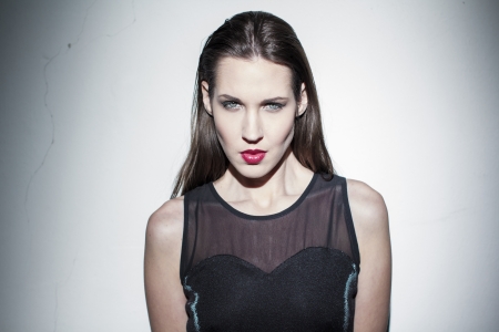 Sensual brunette fashion model portrait at wallの写真素材