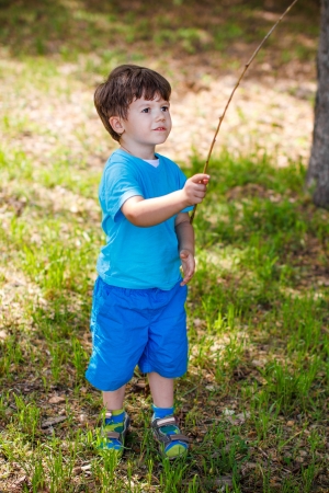 Little boy with branch, childhoodの写真素材