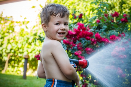 Little boy irrigate in garden, childhoodの写真素材