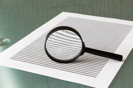 Law investigation, magnifying glass with document on tableの写真素材