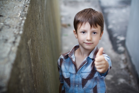 Little boy thumb up, outdoorの写真素材