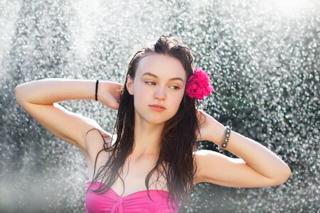 Sexy woman in bikini in the shower, outdoorの写真素材