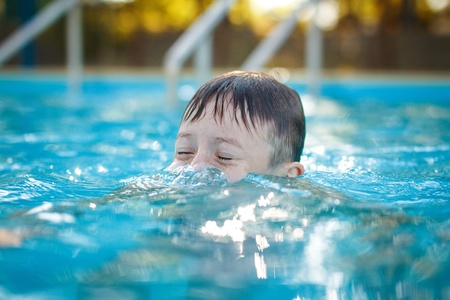 Little preschooler boy playing submarine poolの写真素材