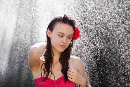 Sexy woman washing hair under shower, outdoorsの写真素材