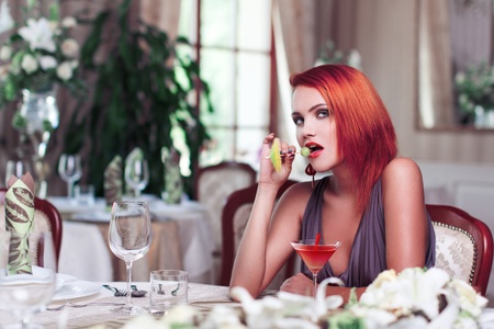 Sexy redhead woman with drink, seductionの写真素材