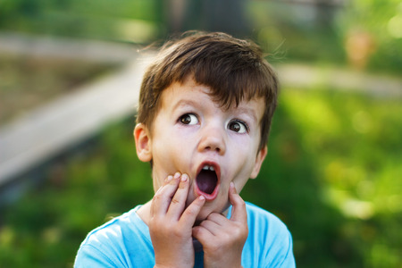 Frightened little caucasian boy, outdoorの写真素材
