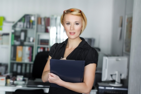 Secretary holding business plan in office, scheduleの写真素材