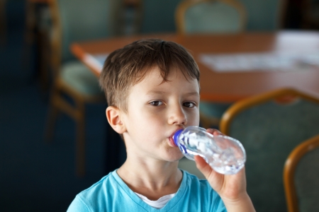 Little boy drink water from bottleの写真素材