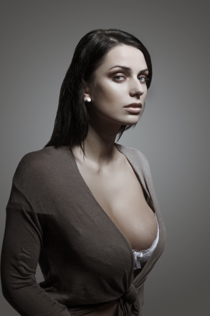 Sexy brunette woman portrait, gray backgroundの写真素材