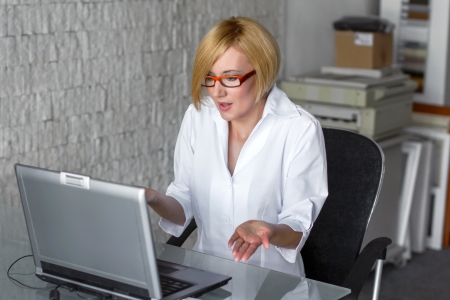 Blonde businesswoman with bad laptopの写真素材