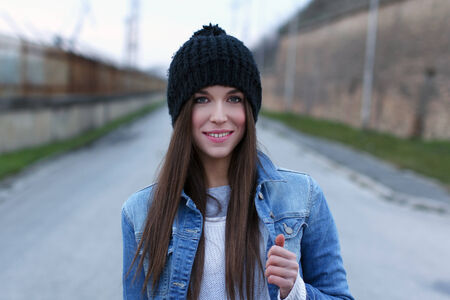 Beautiful brunette woman in winter cap, trendy fashionの写真素材