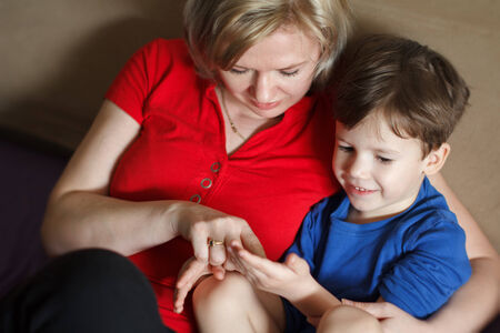 Mom together with little son at homeの写真素材