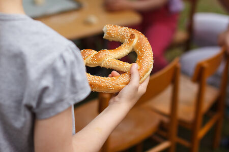 Little boy with pretzel in kindergarten closeupの写真素材