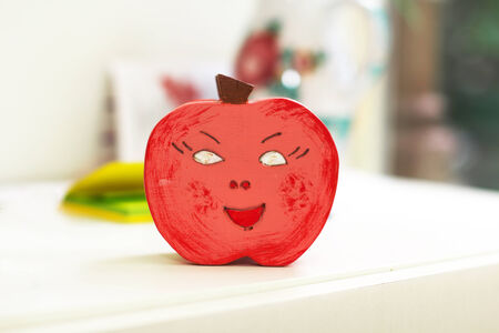 Red painted wooden apple decoration in kindergartenの写真素材