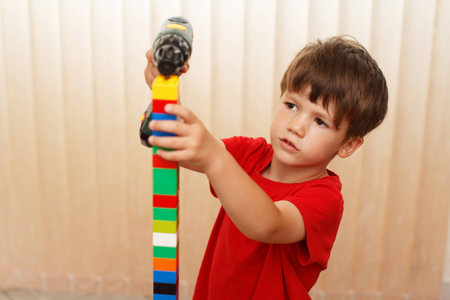 Little boy build tower from blocks, education at homeの写真素材